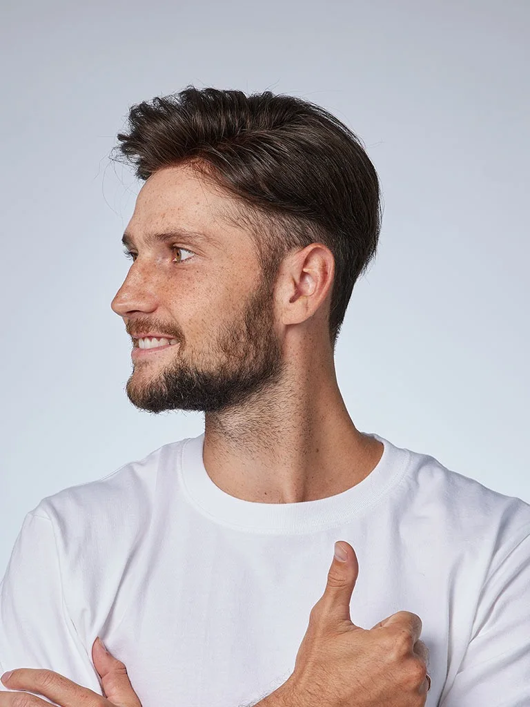 Man in a white T-shirt giving a thumbs up