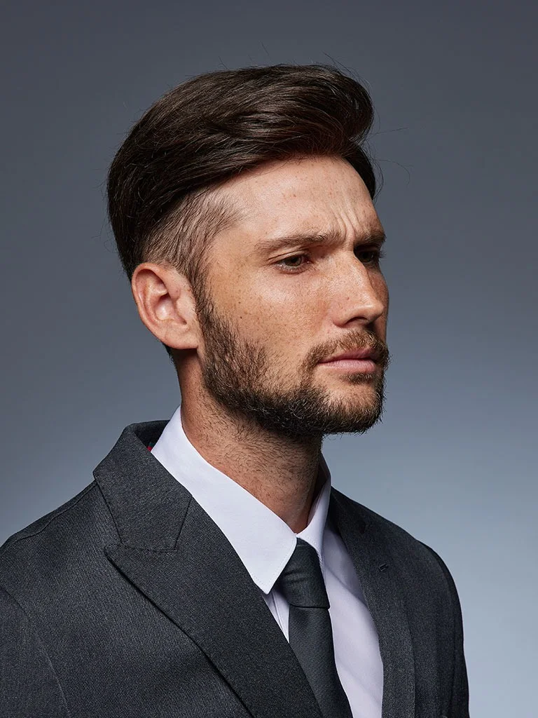 Man in a suit with a classic side part