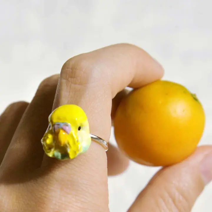 Clay bird head on an adjustable silver ring