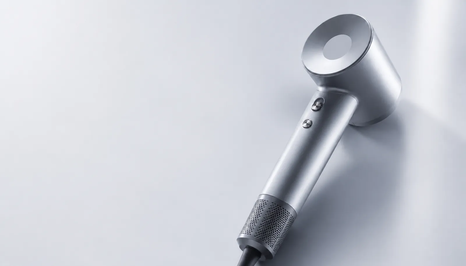 SHYN silver hair dryer in a studio setting