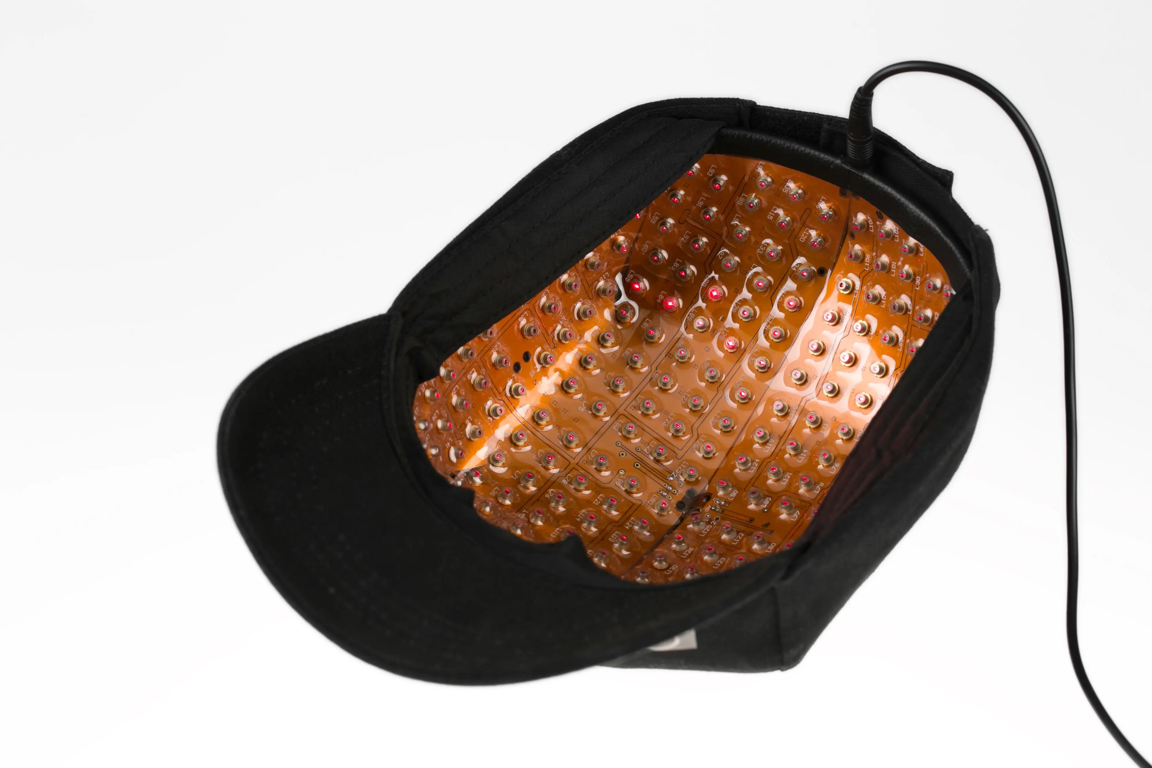 Close-up of the flexible interior and illuminated laser-diode array inside a ReHair laser cap