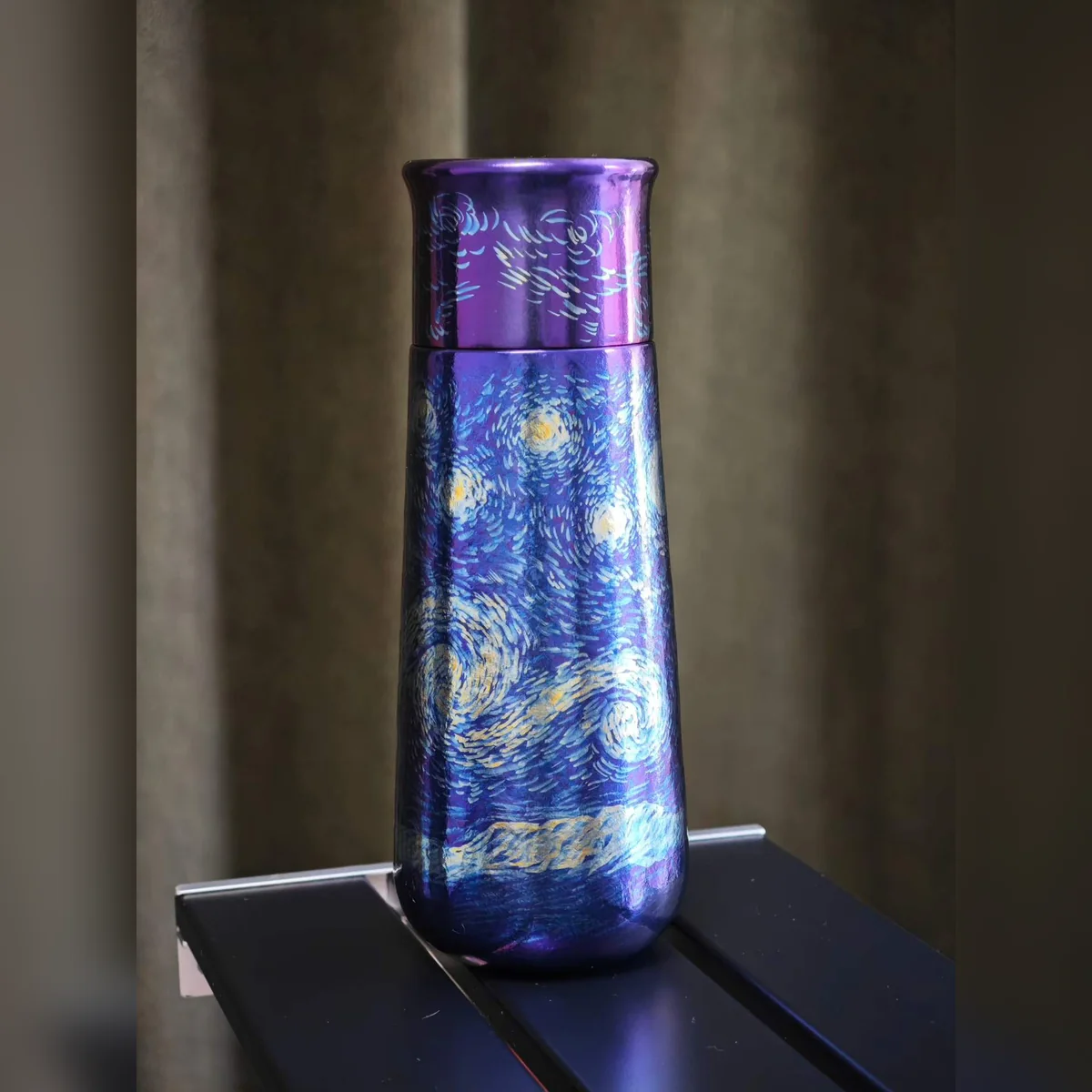 Tall bottle painted with swirling stars inspired by Van Gogh