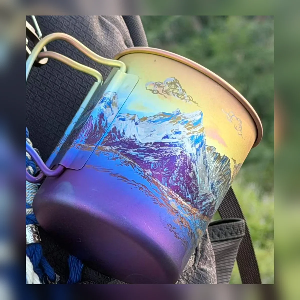 Camp mug with folding handles painted with a snowy ridge at twilight