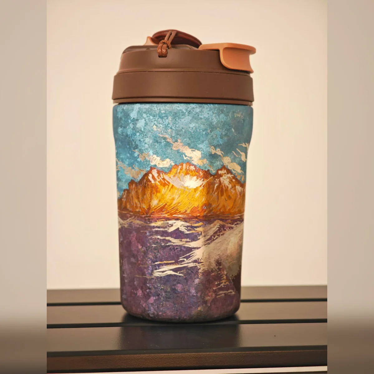 Travel tumbler painted with an orange sunset ridge – view 2