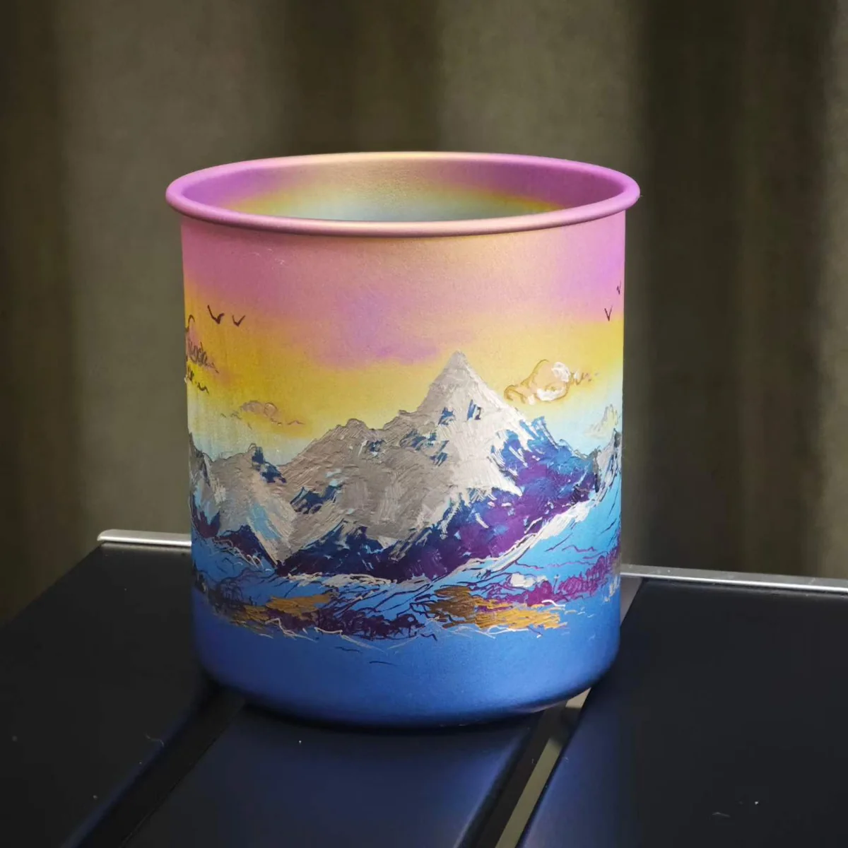 Camp mug painted with a mountain range under a pink sunrise